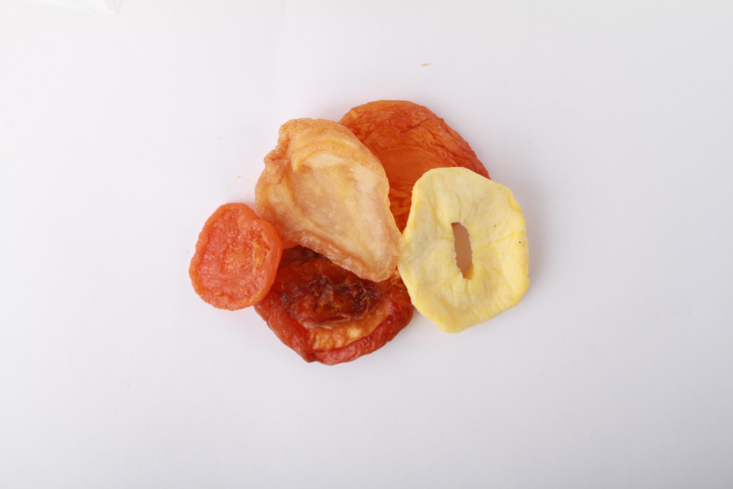Traina® Deluxe Mixed Dried Fruit - small pile of dried fruit on white background.