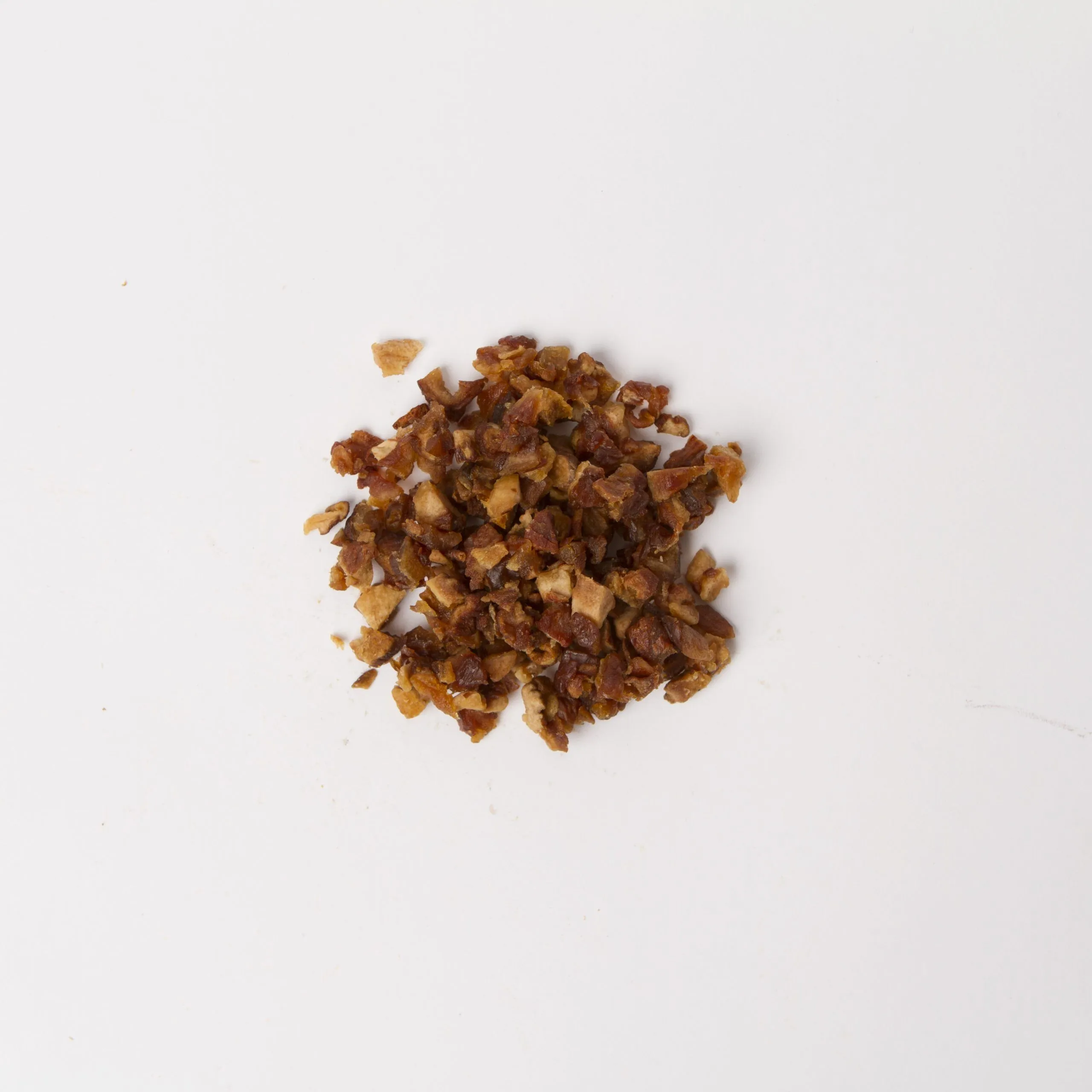 Traina® Organic Dried Pears, double-diced - small pile of sun dried fruit on white background.