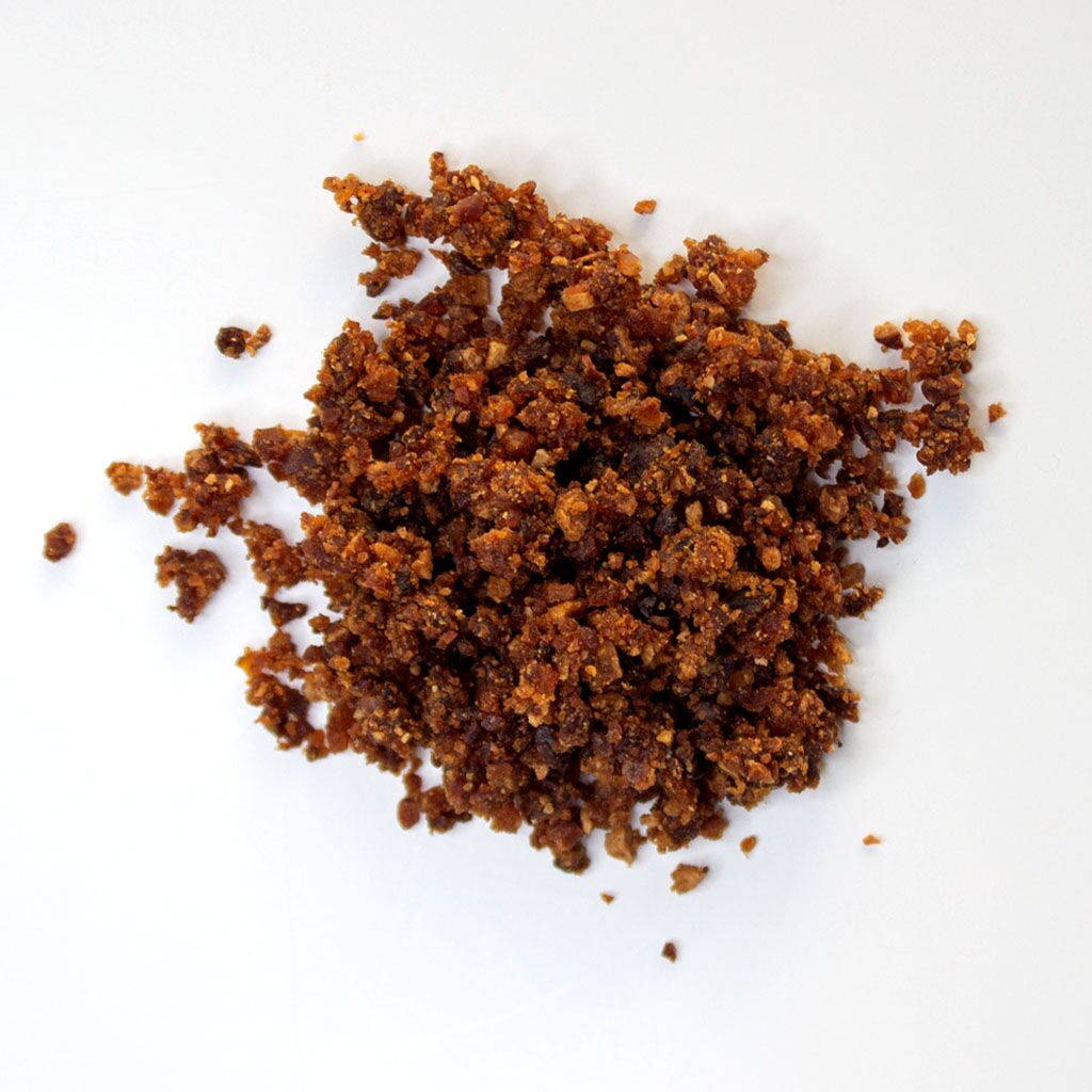 Traina® Natural Dried Pears, granules - small pile of sun dried fruit on white background.