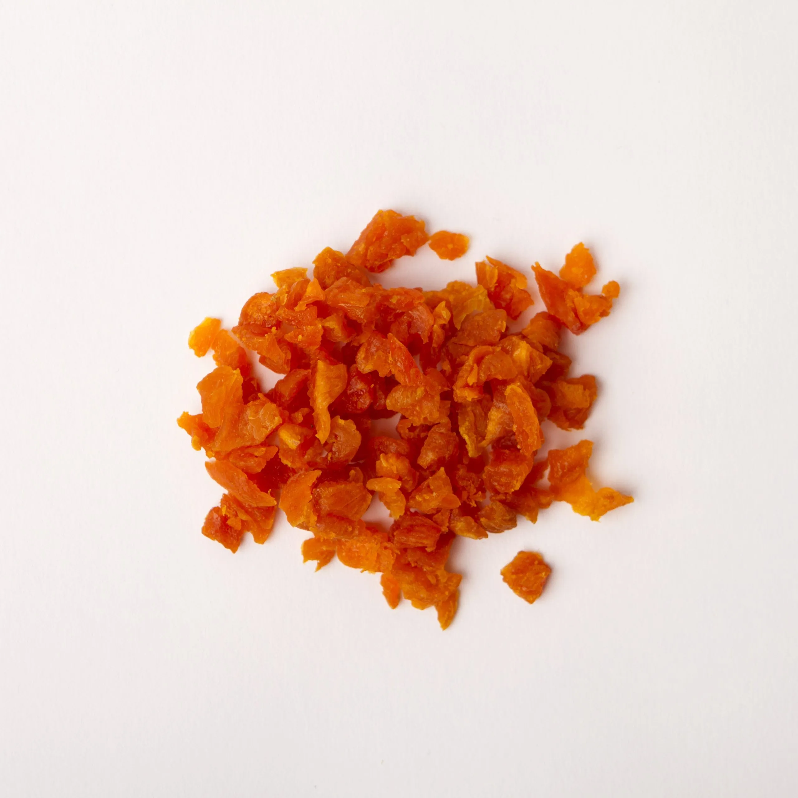 Traina® California Sun Dried Apricots, double-diced - small pile of sun dried fruit on white background.