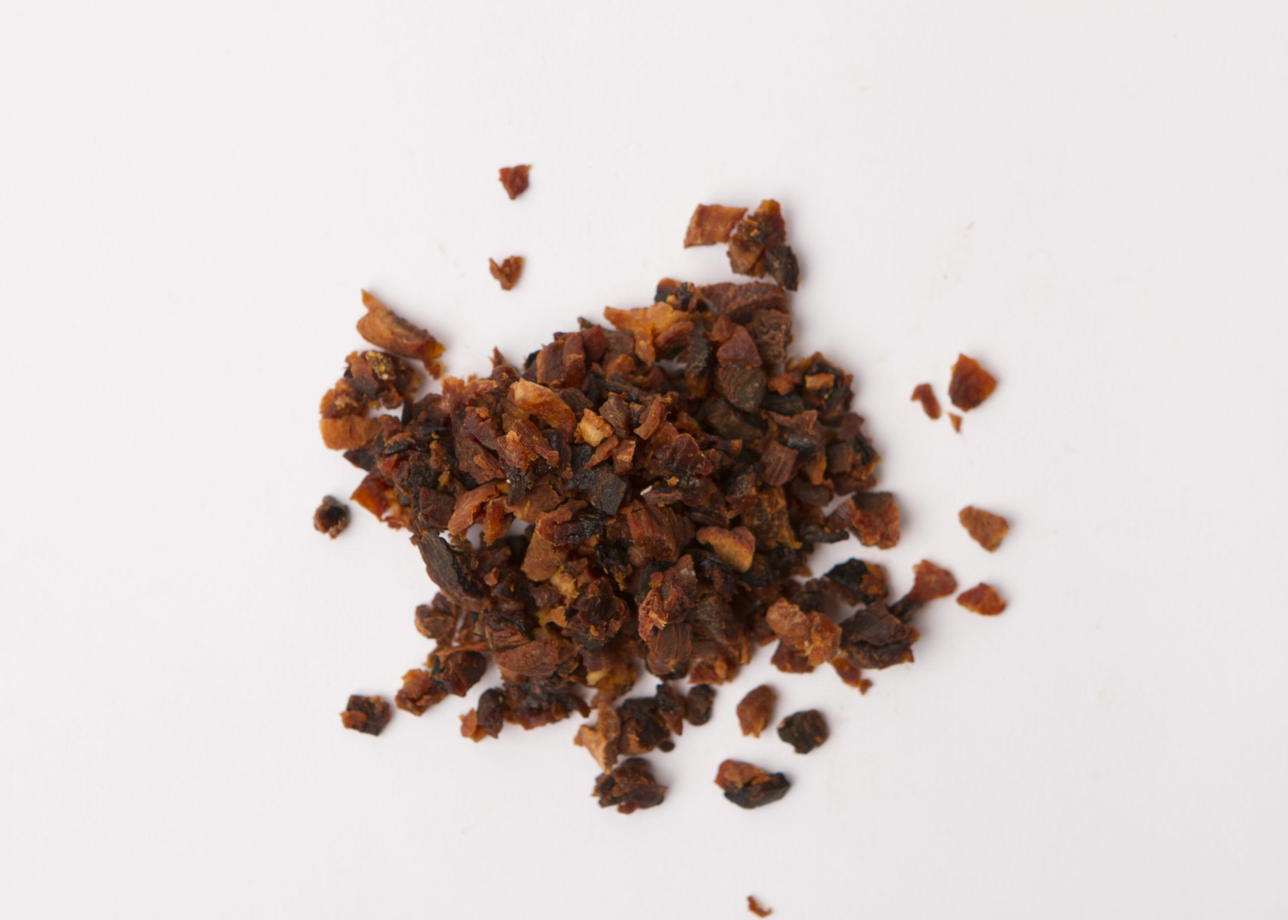 Traina® Natural California Sun Dried Apricots, double-diced - small pile of sun dried fruit on white background.