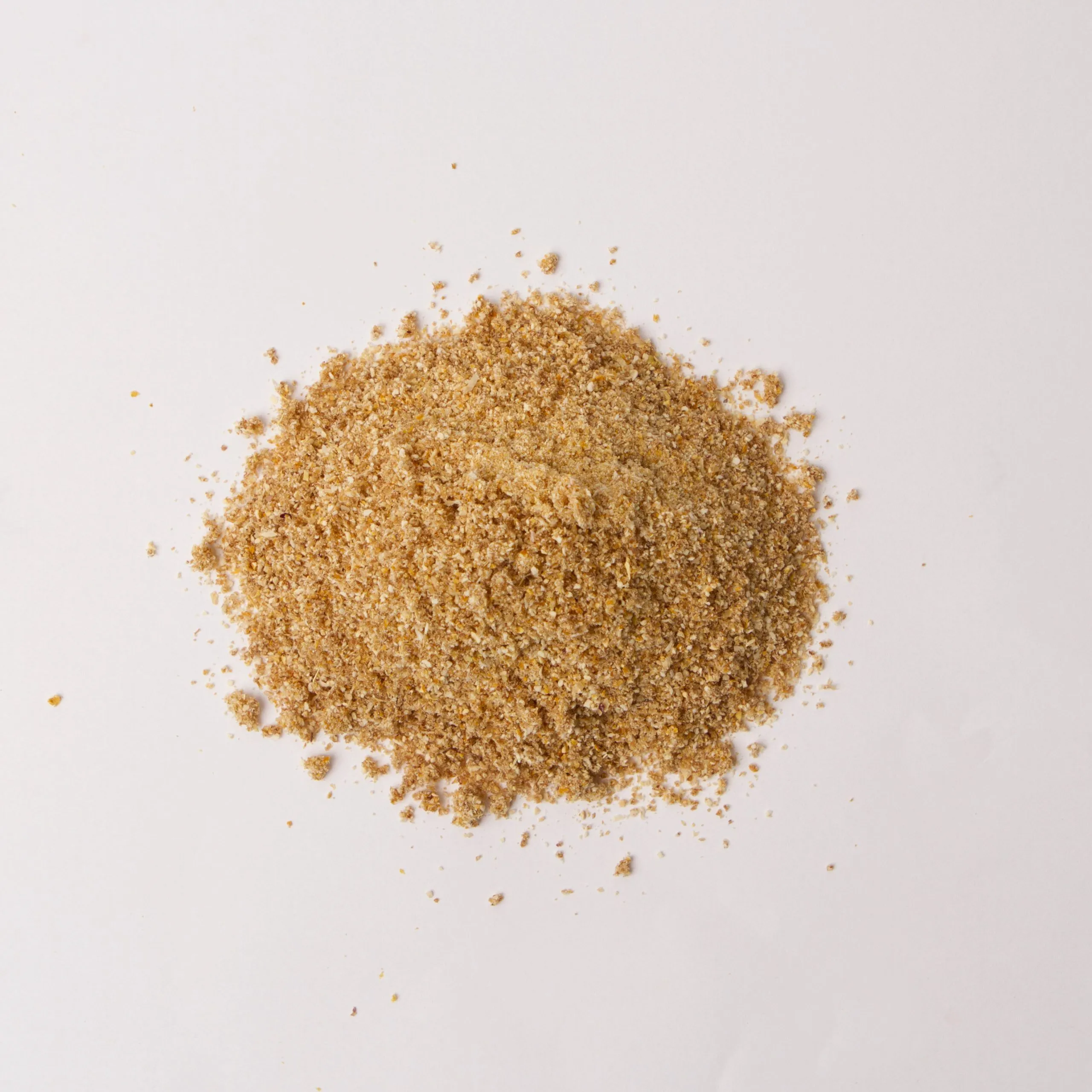 Traina® Natural Dried Lemon, powder - small pile of dried fruit on white background.