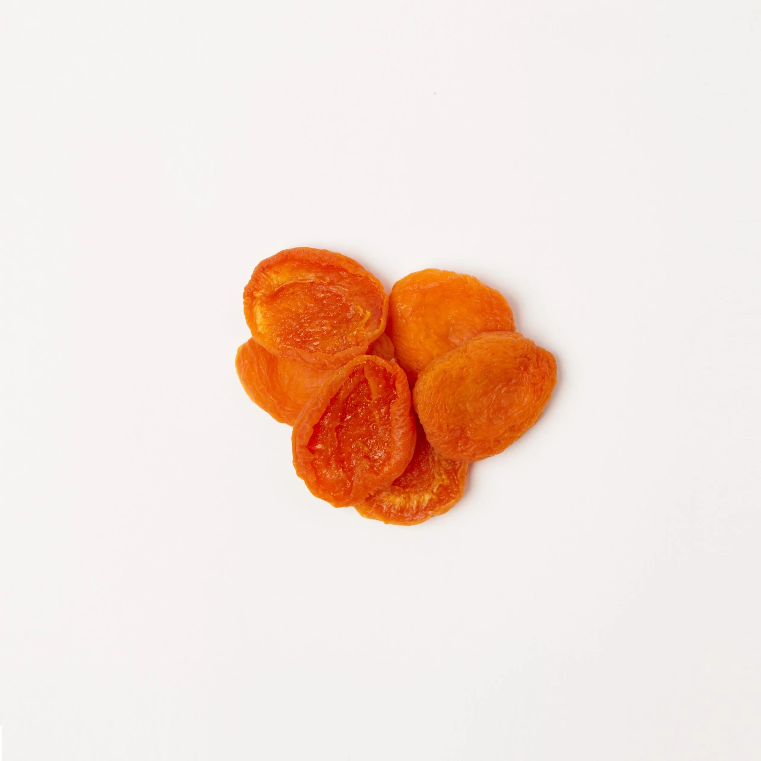 Traina® California Sun Dried Apricots, Fancy, halves - small pile of sun dried fruit on white background.