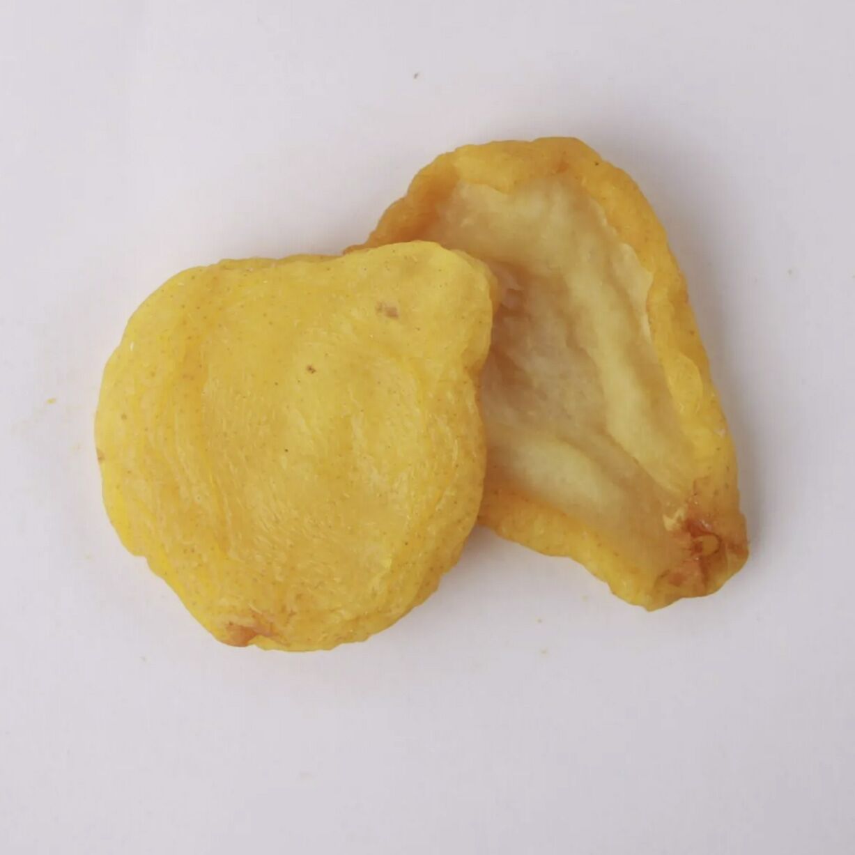 Traina® Dried Pears, Extra Fancy, halves - small pile of sun dried fruit on white background.
