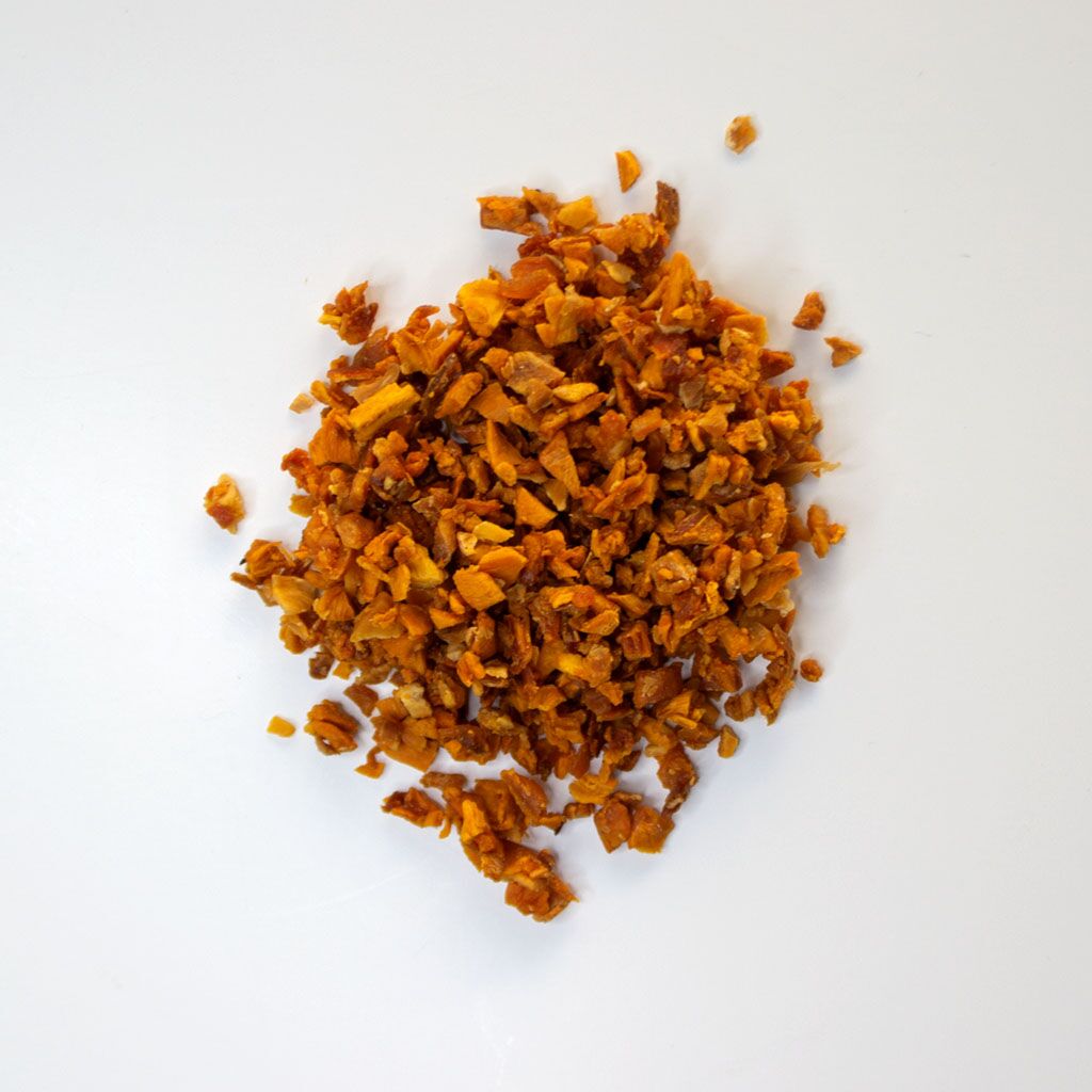 Traina® Natural Dried Mango, Double-Diced. No Added Sugar, double-diced - small pile of dried fruit on white background.