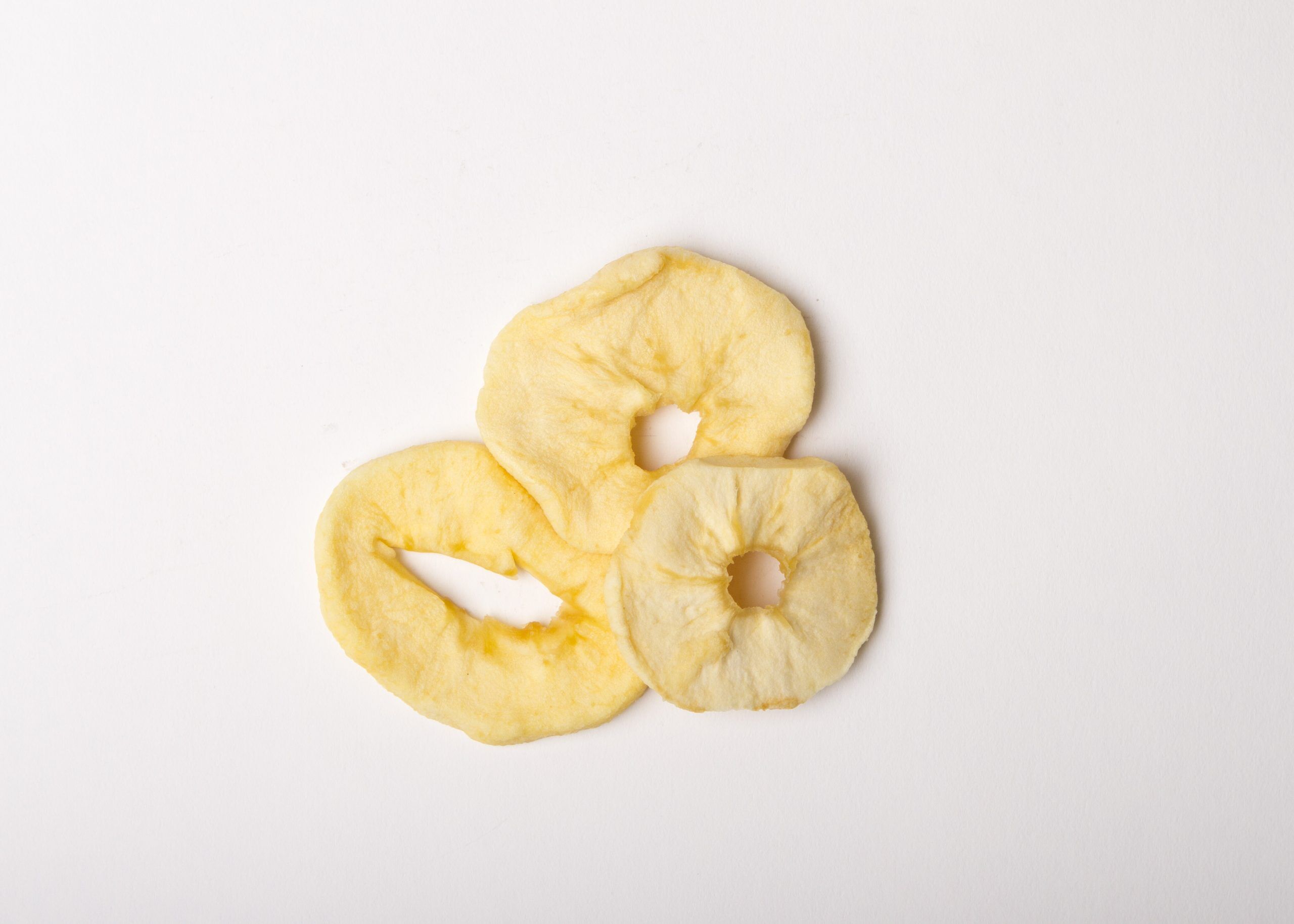 Traina® Dried Apple, rings, with Sulfur - small pile of dried fruit on white background.