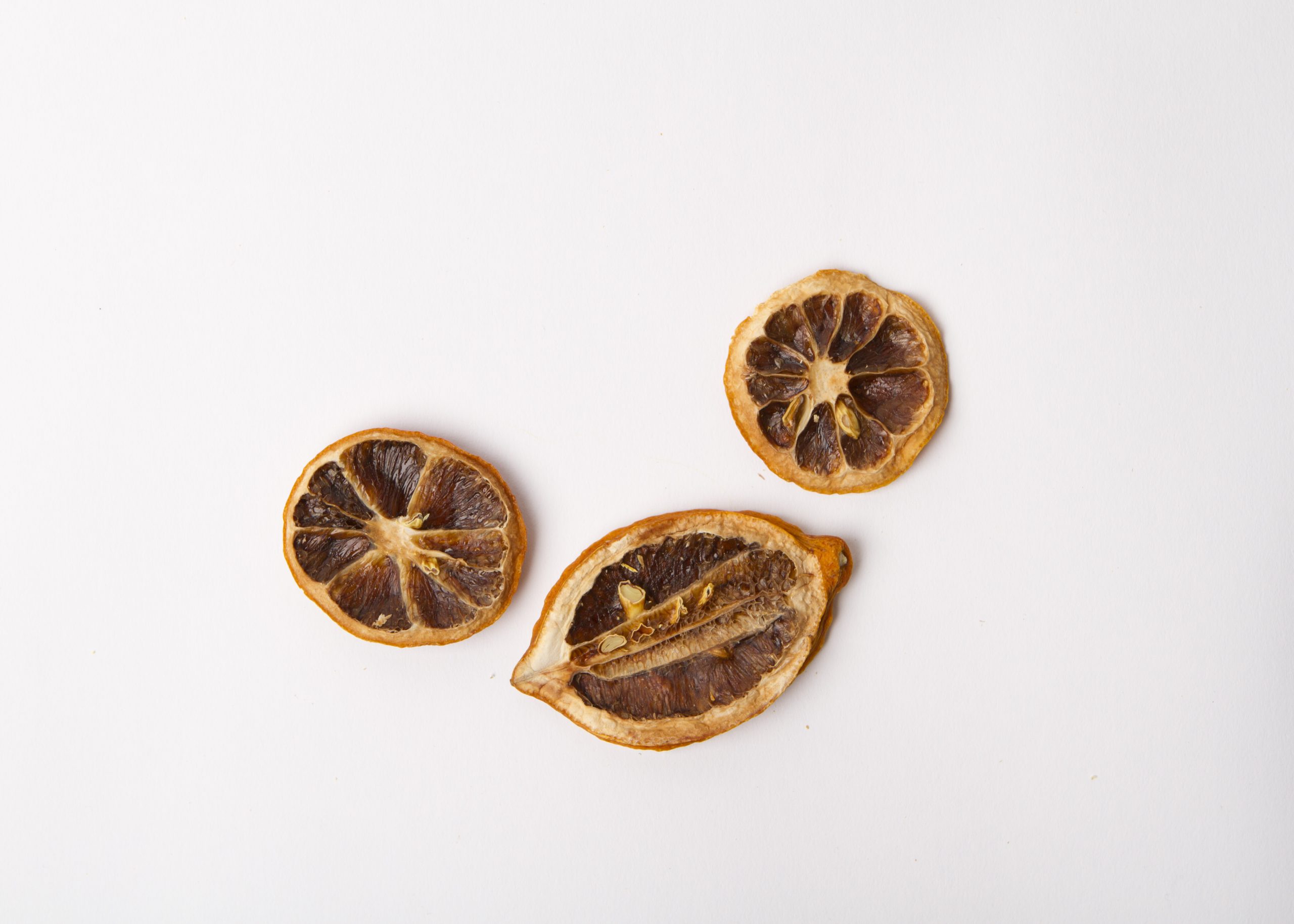 Traina® Natural Dried Lemon, slices - three slices of dried fruit on white background