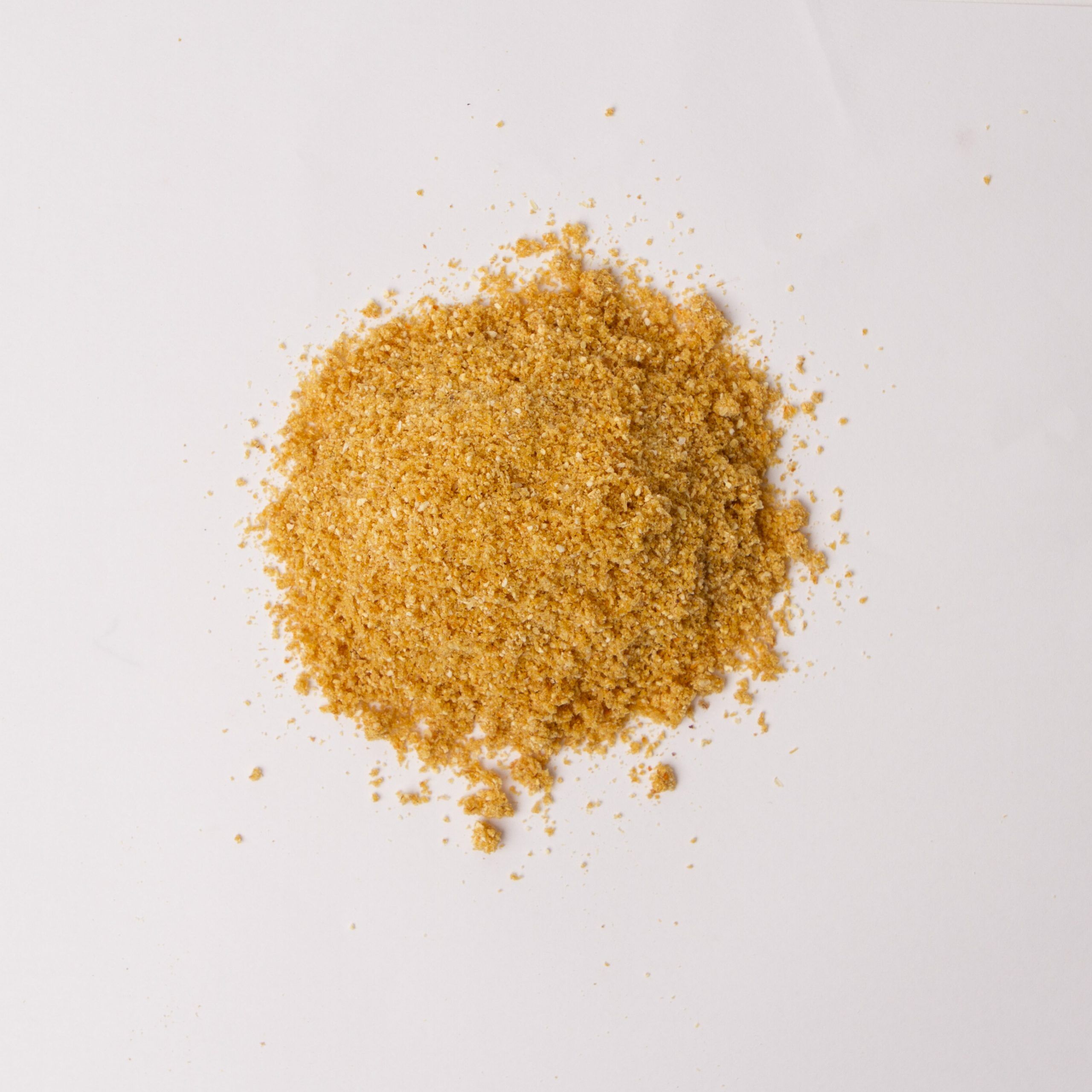 Traina® Natural Dried Orange, powder - small pile of dehydrated fruit on white background