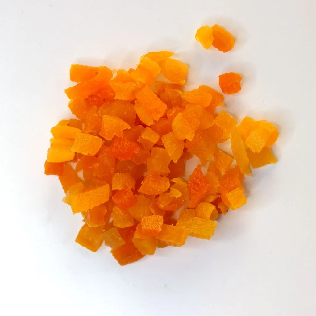 Turkish Apricots, diced - small pile of sun dried fruit on white background.