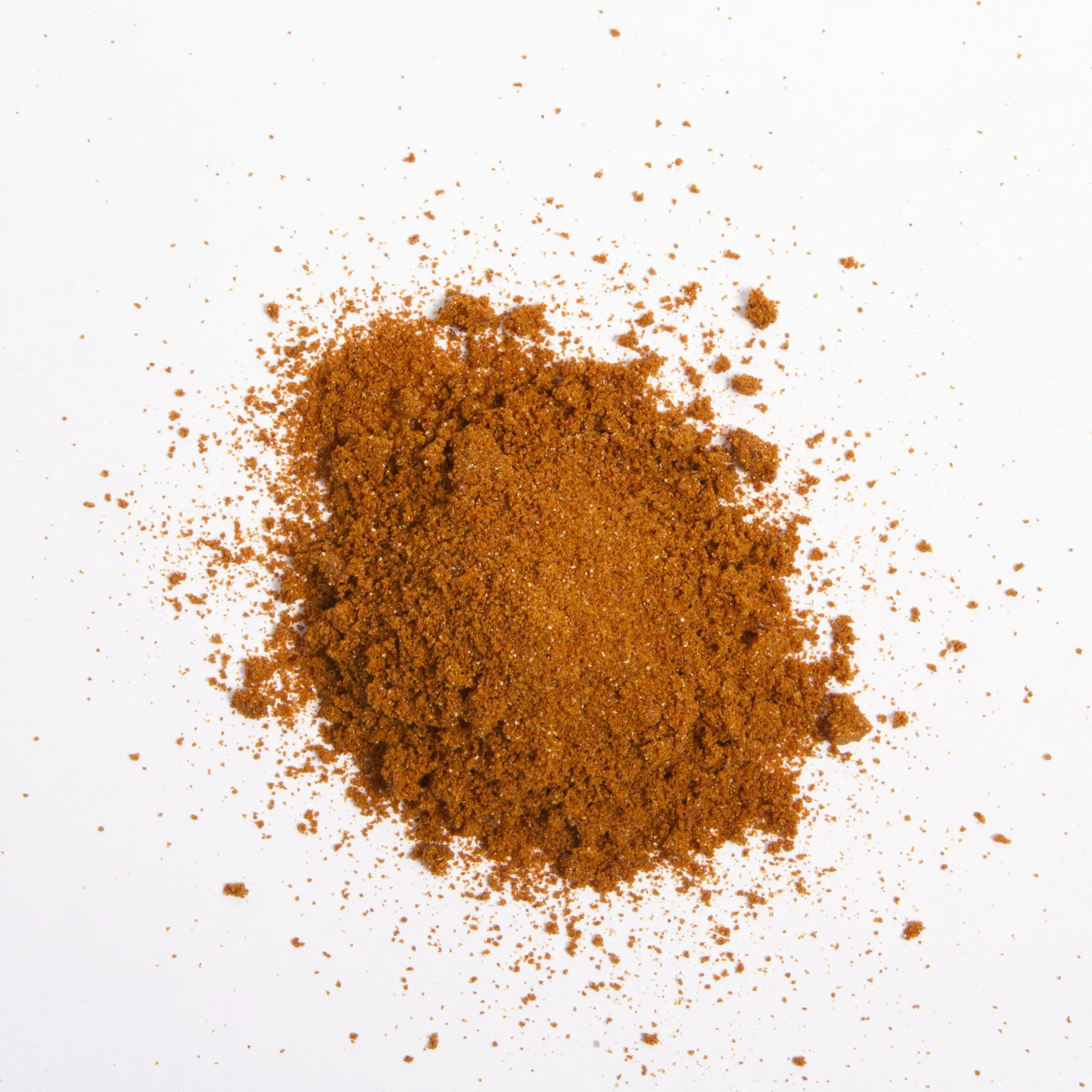 Traina® California Sun Dried Tomato, powder - small pile of sun dried tomato powder on white background.