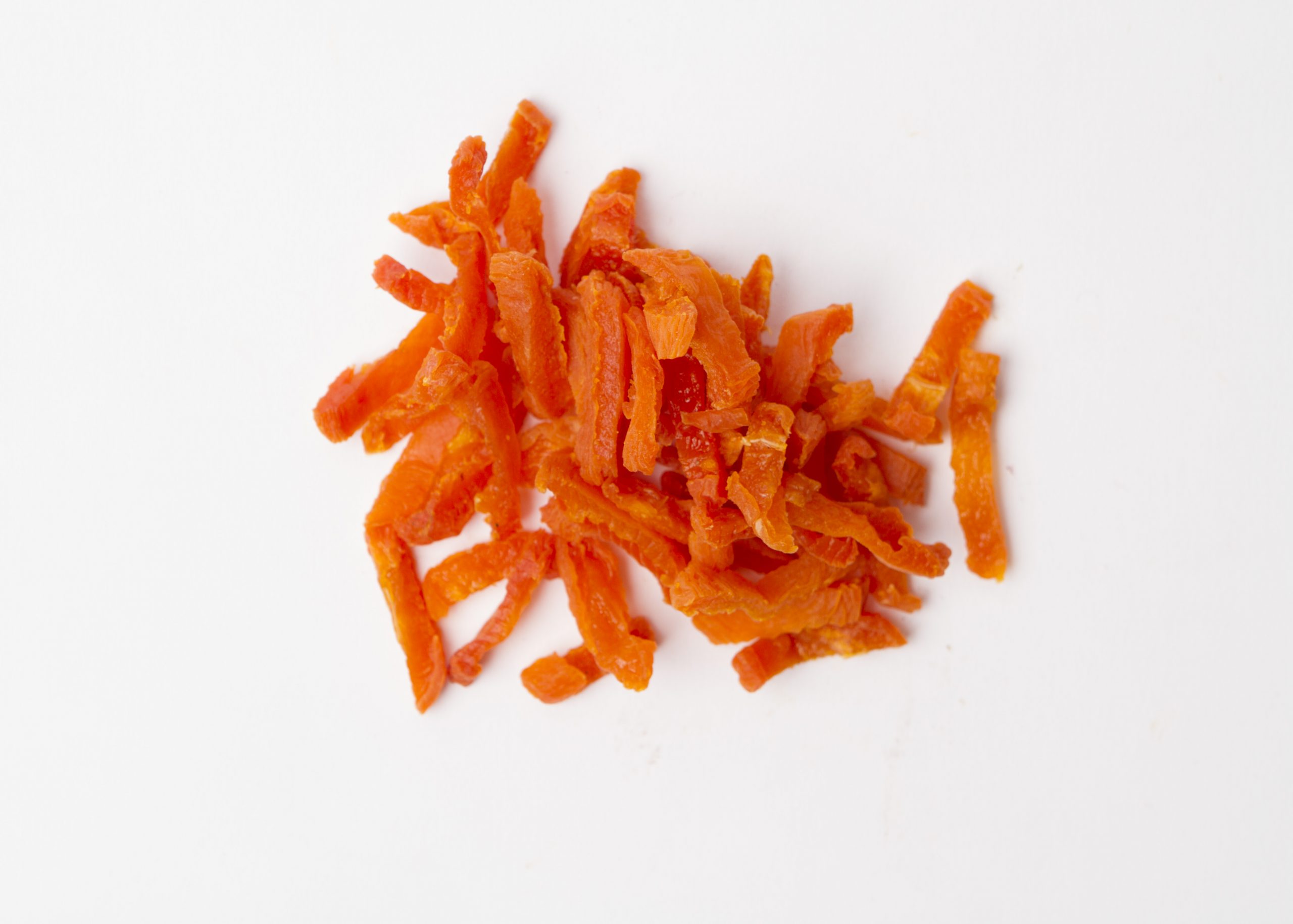 Traina® California Sun Dried Apricots, julienne cut - small pile of sun dried fruit on white background.