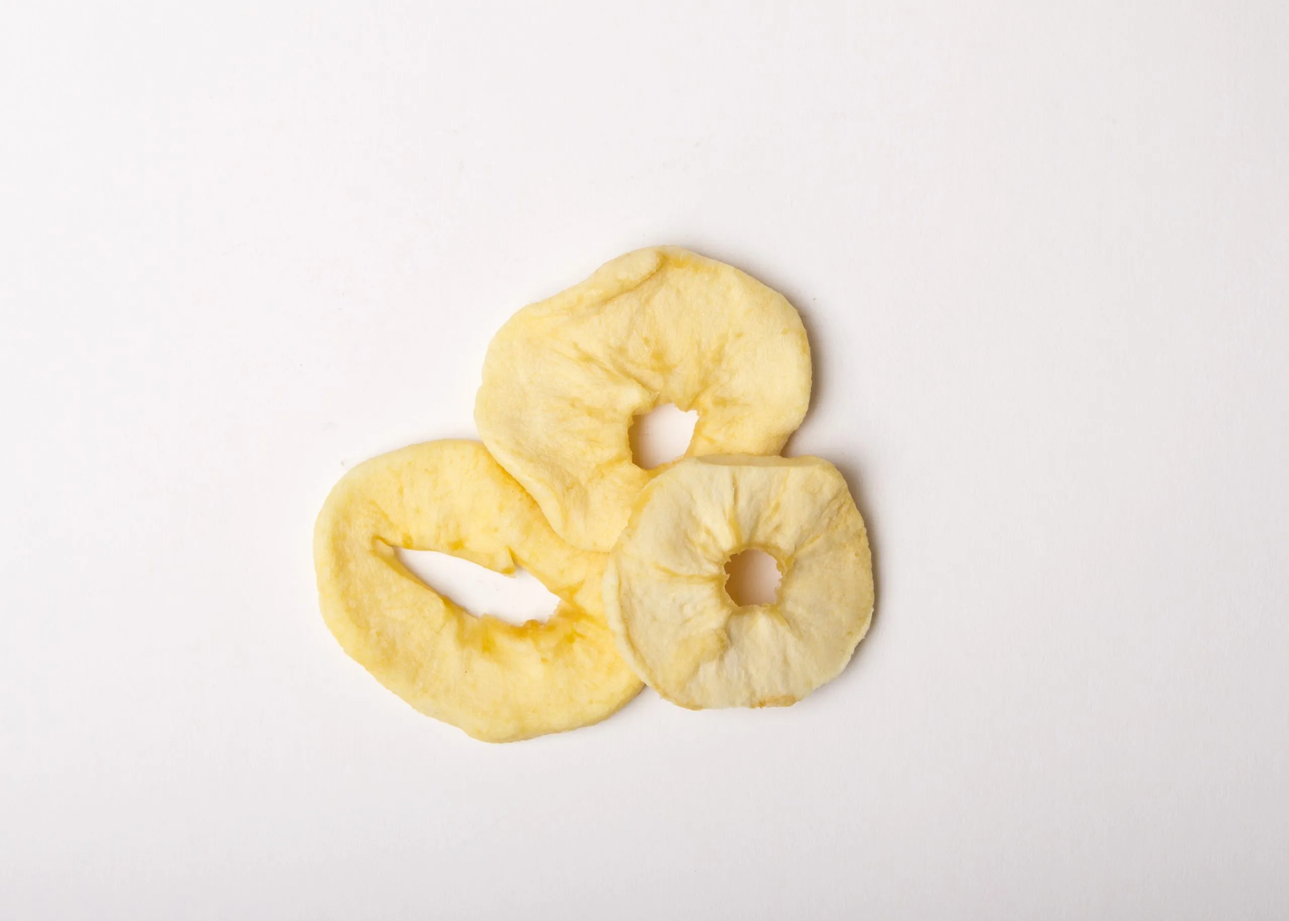Traina® Dried Apple, rings, with Sulfur - small pile of dried fruit on white background.