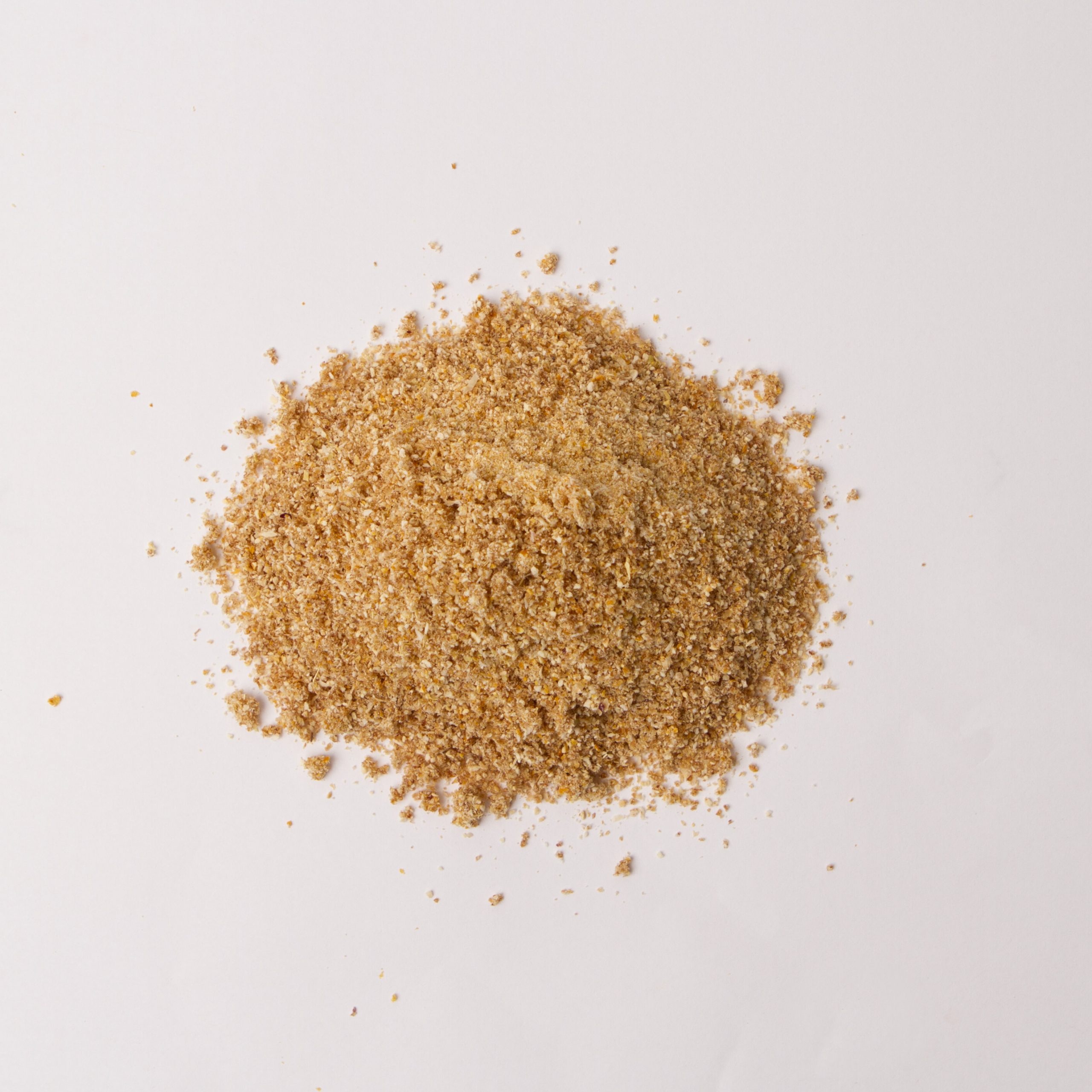 Traina® Natural Dried Lemon, powder - small pile of dried fruit on white background.
