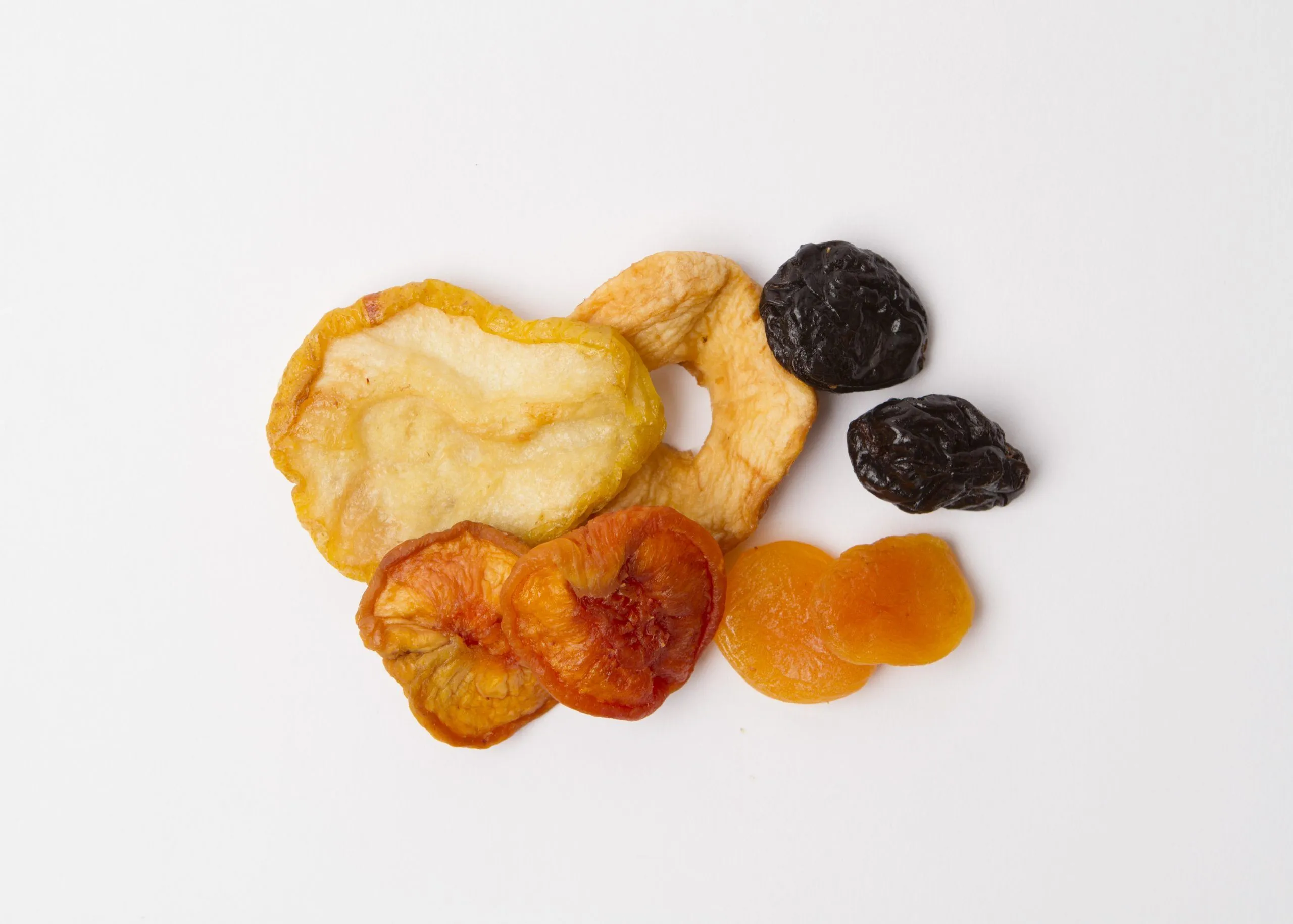 Traina® Select Mixed Fruit. Small pile of dried fruit on white background.
