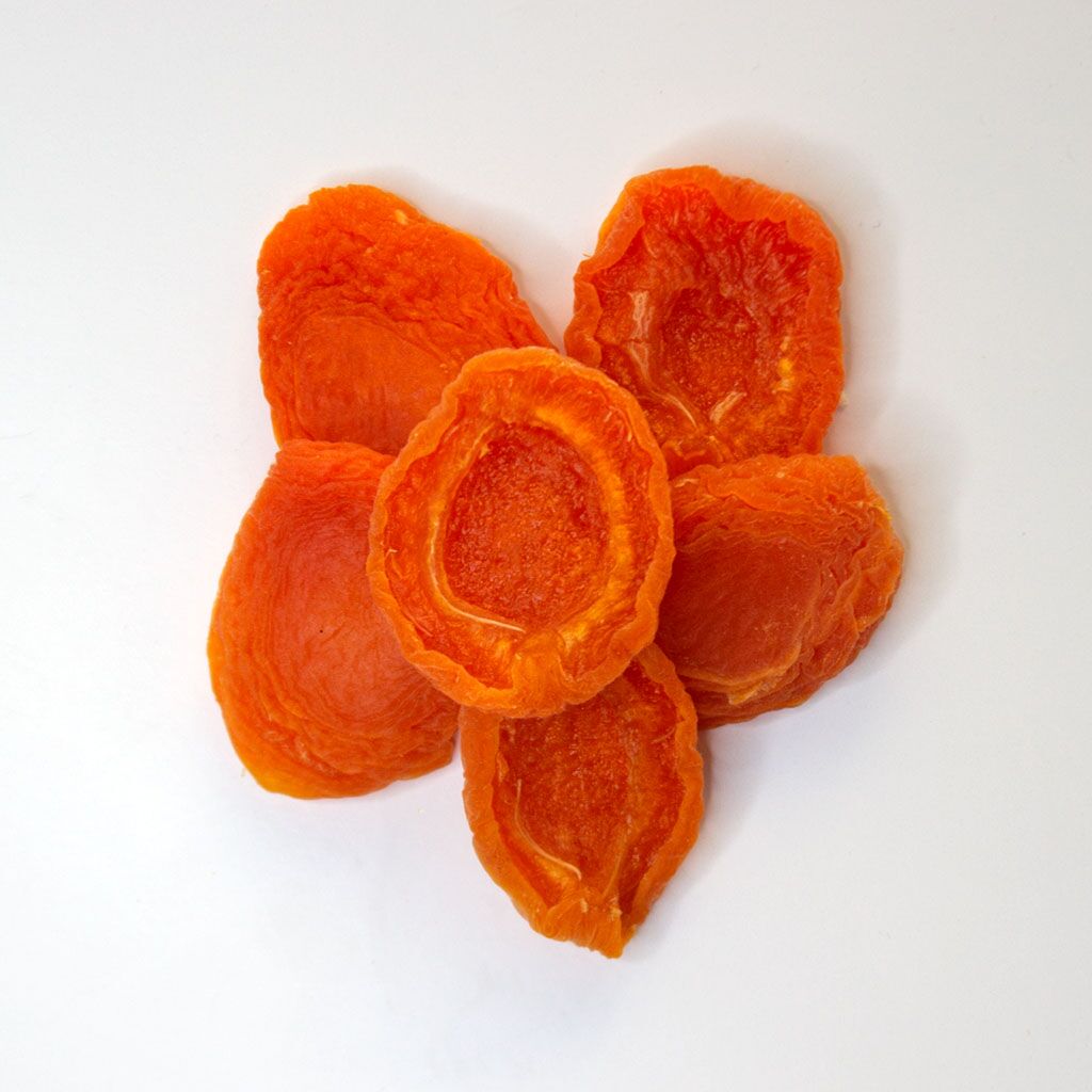 Traina® California Sun Dried Apricots, Extra Choice, halves - small pile of sun dried fruit on white background.