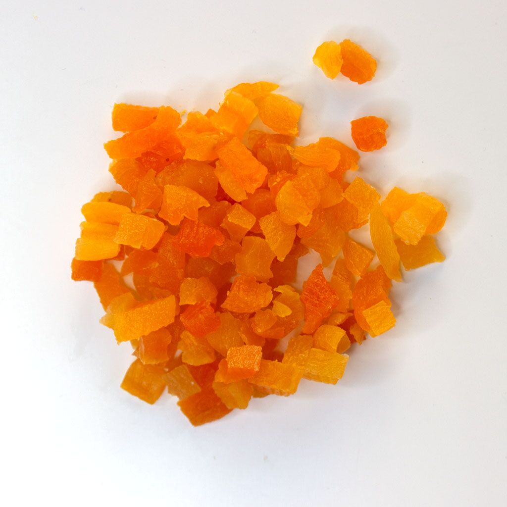 Turkish Apricots, diced - small pile of sun dried fruit on white background.