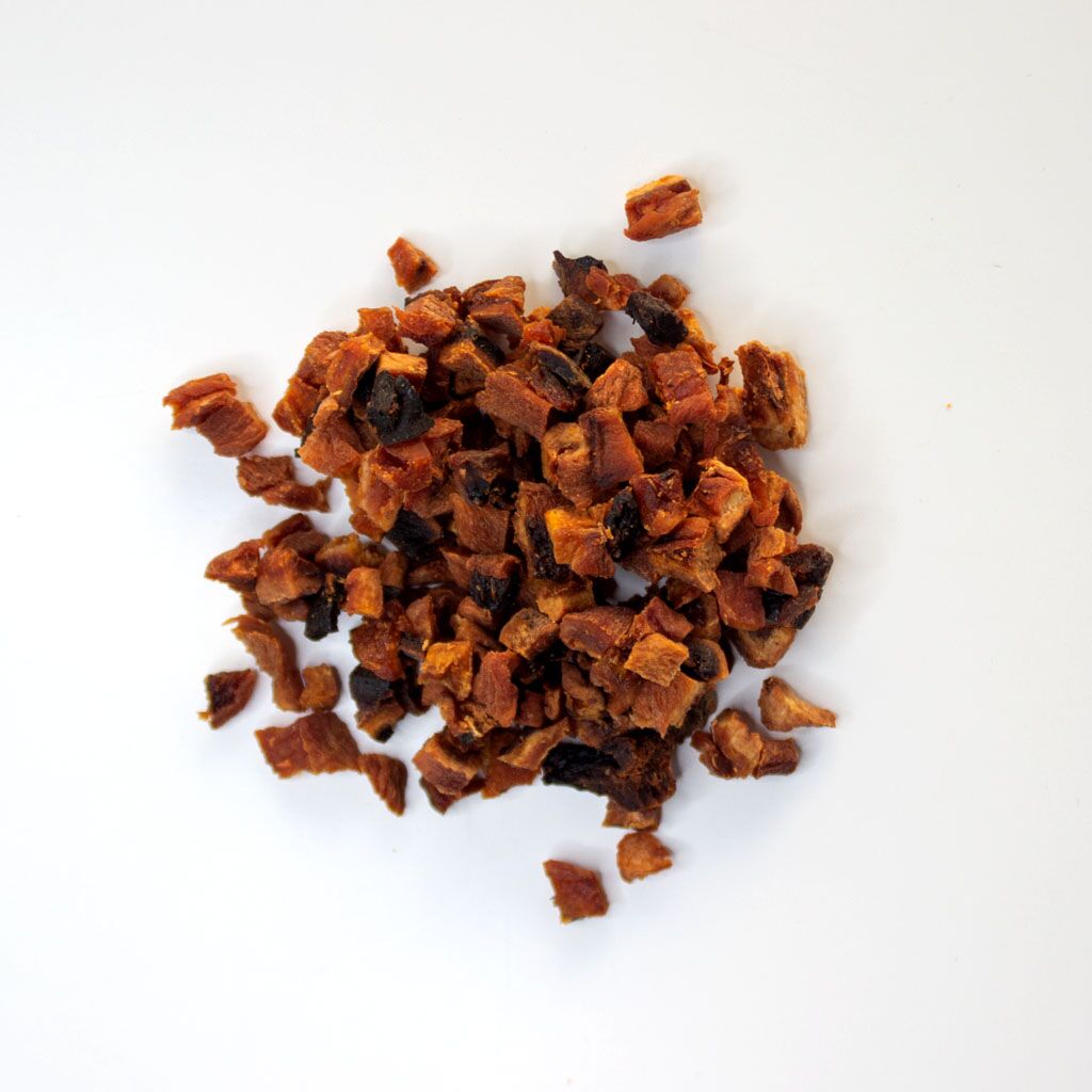 Traina® Organic California Sun Dried Apricots, diced - small pile of sun dried fruit on white background.