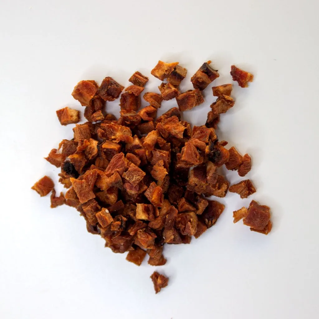 Traina® Natural California Sun Dried Apricots, diced - small pile of sun dried fruit on white background.
