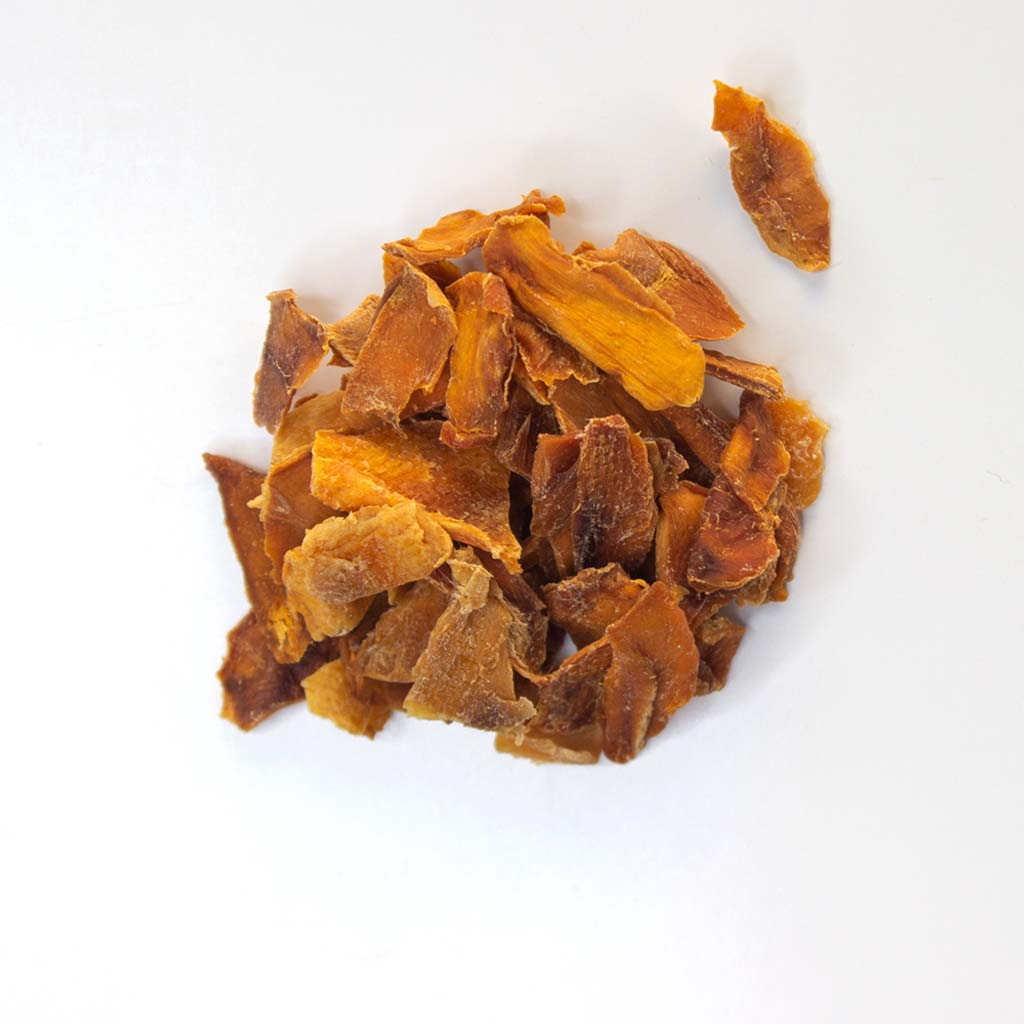 Traina® Organic Dried Mango - diced. Small pile of dried fruit on white background.