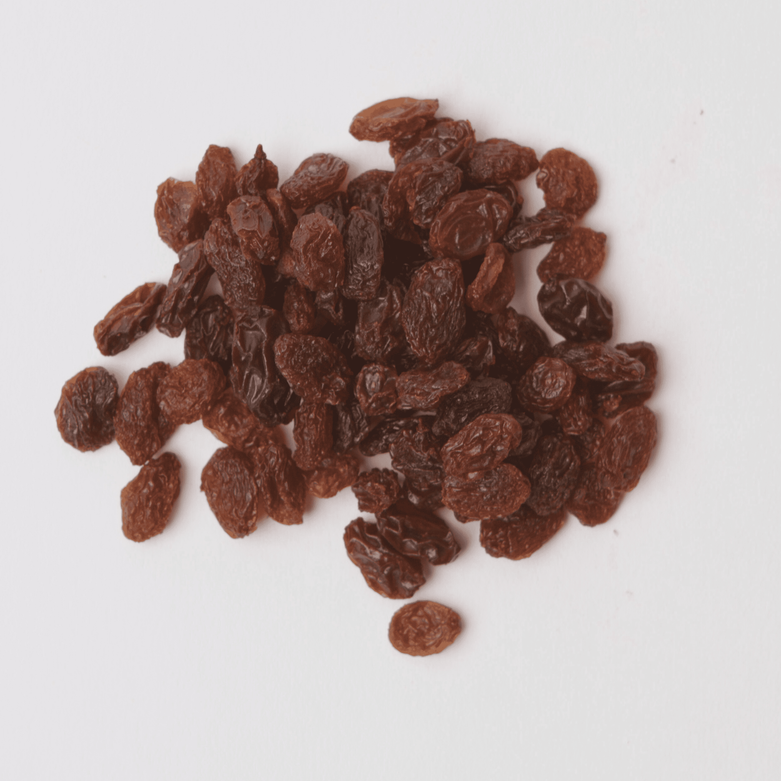 Traina® Dried Fruit Dark Raisins - small pile of dried fruit on white background