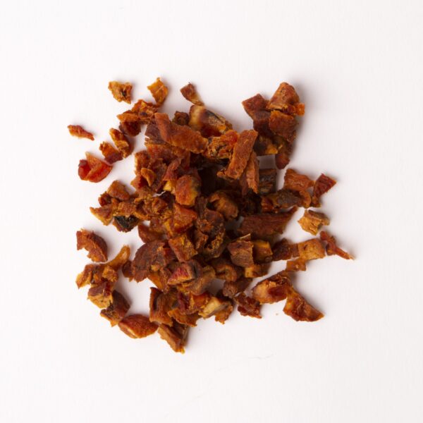 Traina® Organic California Sun Dried Apricots, double-diced - small pile of sun dried fruit on white background.