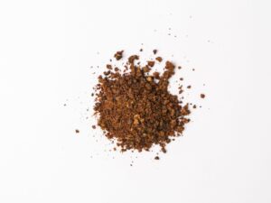 Traina® Natural California Sun Dried Apricots, granules - small pile of sun dried fruit on white background.