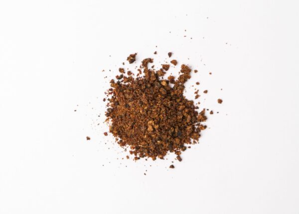 Traina® Natural California Sun Dried Apricots, granules - small pile of sun dried fruit on white background.