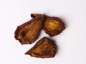 Traina® Organic Dried Pears, halves - small pile of sun dried fruit on white background.