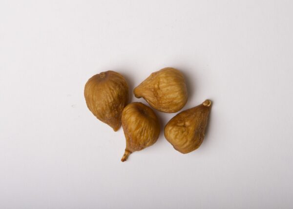 Traina® California Dried Sierra Figs - small pile of dried fruit on white background.