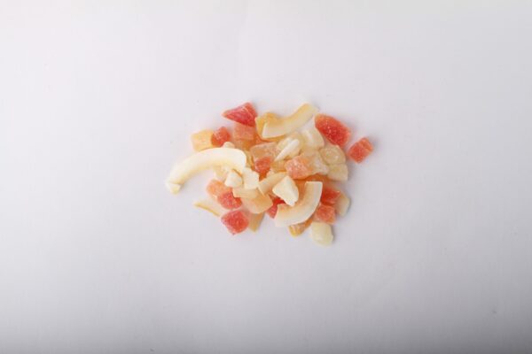 Traina® Tropical Fruit Blend - small pile of mixed dried fruit on white background.