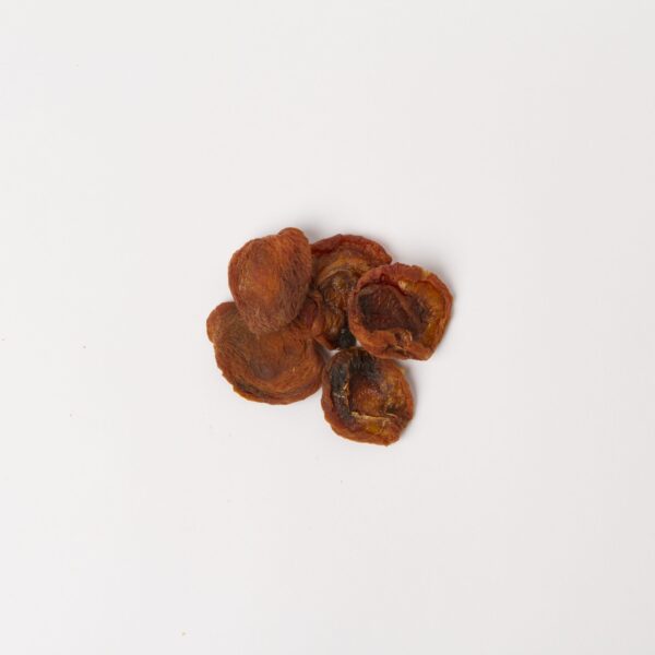 Traina® Natural California Sun Dried Apricots, halves - small pile of sun dried fruit on white background.