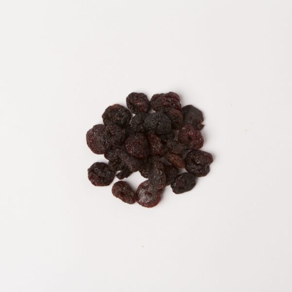 Traina® California Sun Dried Bing Cherries,Whole, pitted - small pile of sun dried fruit on white background.