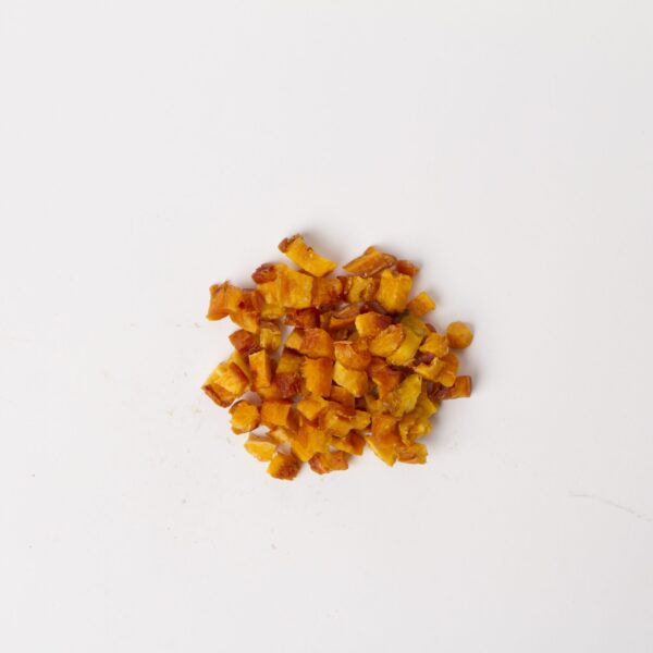 Traina® California Sun Dried Nectarines, diced - small pile of sun dried fruit on white background.