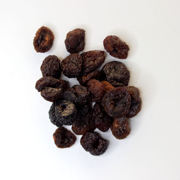 Traina® Organic California Sun Dried Rainer Cherries, pitted, whole - small pile of sun dried fruit on white background.