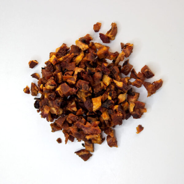Traina® Natural California Sun Dried Peaches, double-diced - small pile of sun dried fruit on white background.