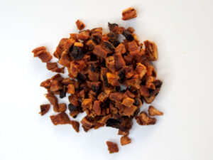 Traina® Organic California Sun Dried Apricots, diced - small pile of sun dried fruit on white background.