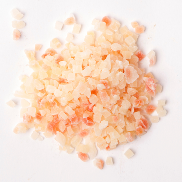 Traina® Dried Papaya, Sweetened, with Sulfur, diced 3-5mm - small pile of dried fruit on white background.