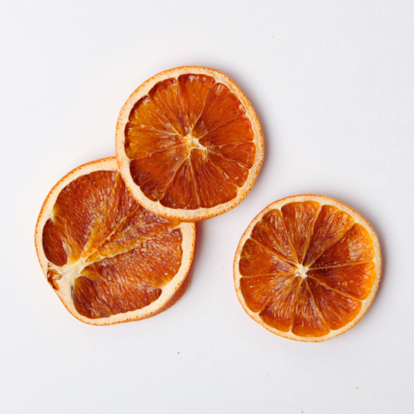 Traina® Organic Dried Orange, slices - three pieces of dried fruit on white background