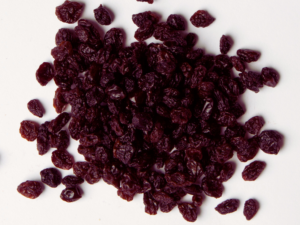 Traina® Dried Zante Currants - small pile of dried fruit on white background